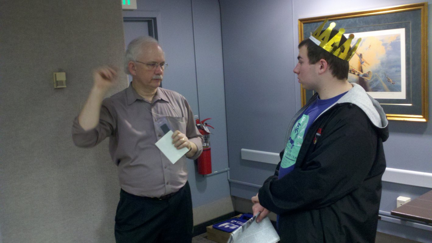 A CUA student talks with Dr. Michael Neufeld, a curator at the Air and Space Museum.