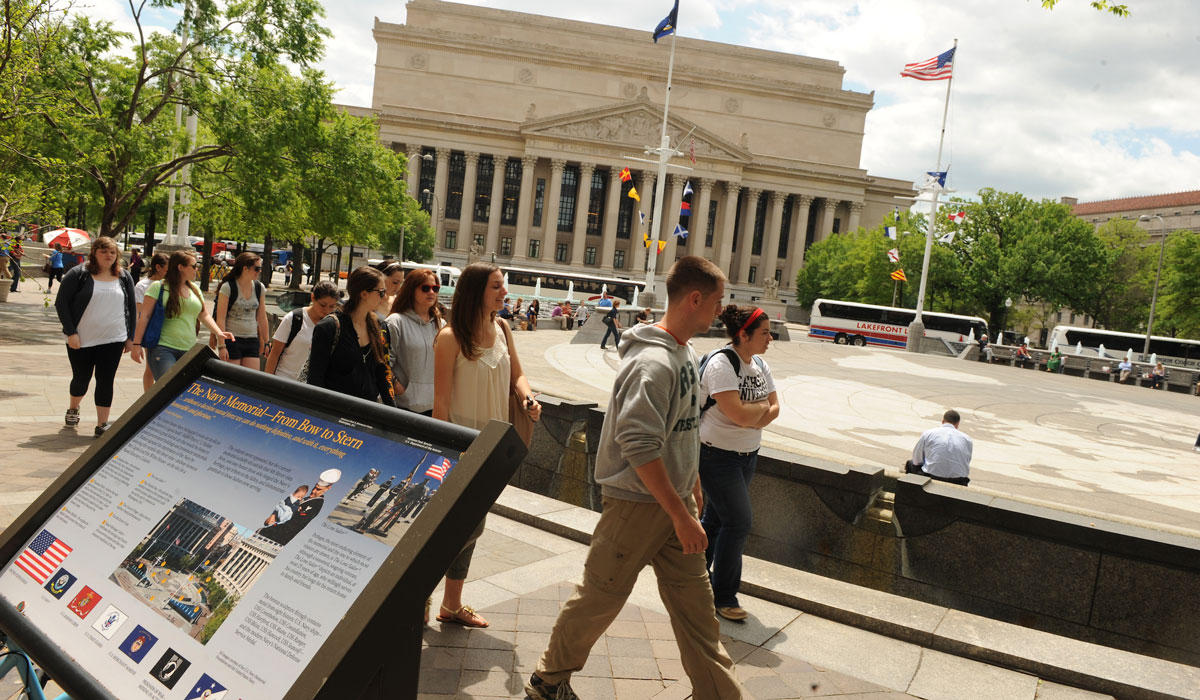 Students walking through DC with National Archives in the background