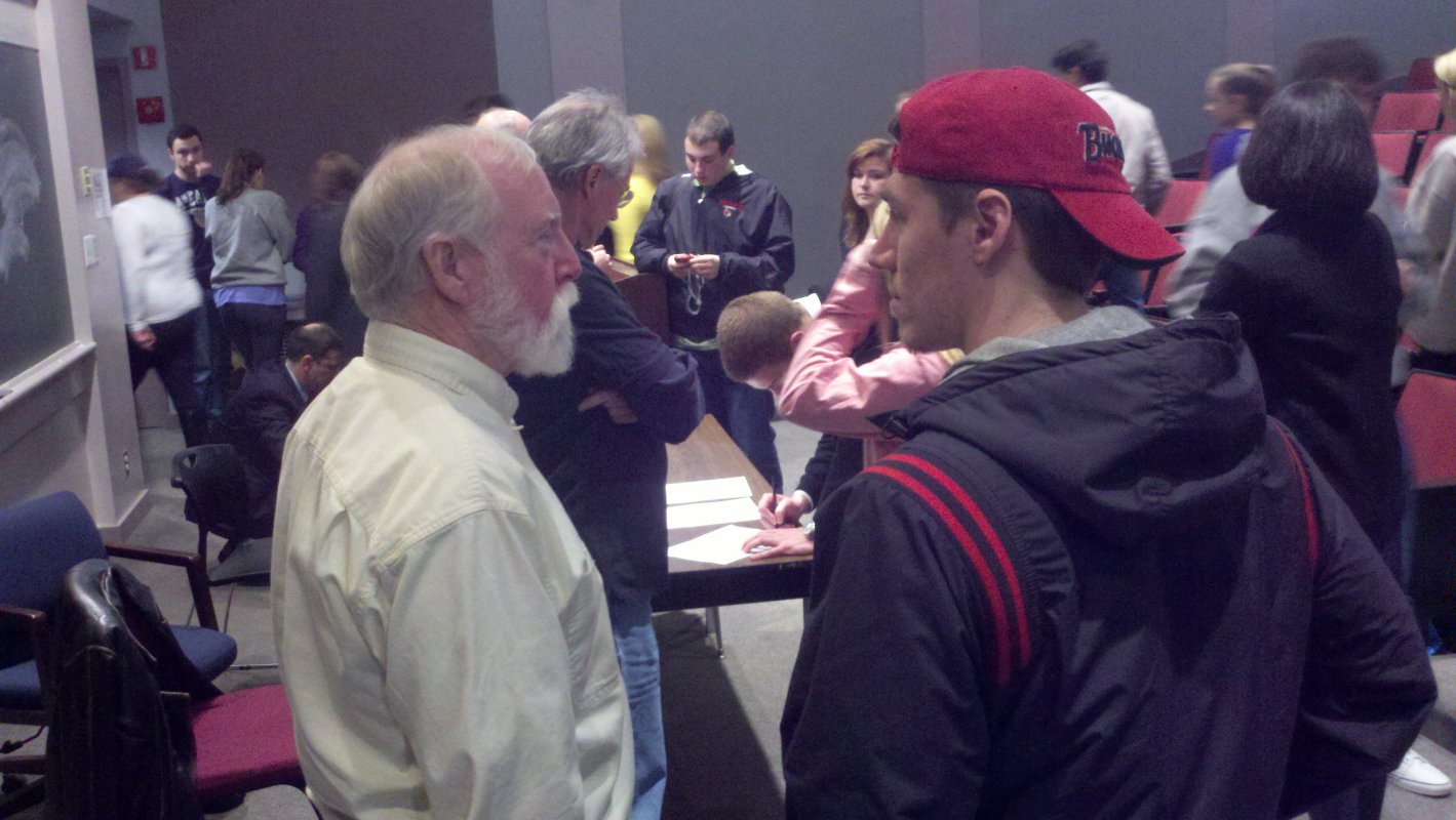 A student talks with a Vietnam War veteran following a presentation by him and two other veterans on their experiences during the war.